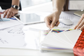 The hands of women who are looking for a material