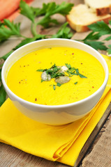 Pumpkin cream soup decorated seeds and herbs