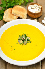 Pumpkin soup on rustic wooden table