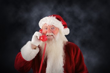Composite image of santa claus on the phone