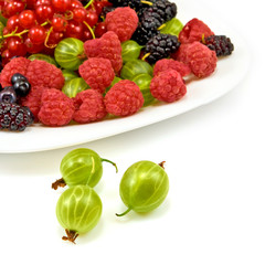 berries in a plate on a white background