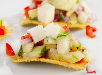 Nachos with vegetables and cheese.