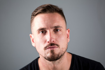 Man with facial hair and serious look