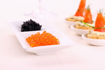 Red and black caviar with smoked salmon rolls