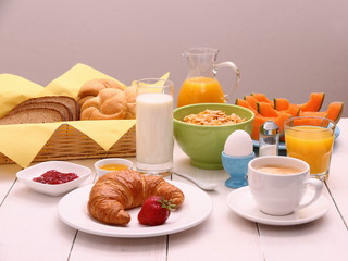 Healthy breakfast with croissants, cup of coffee and fruits