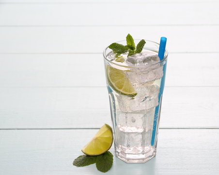 Refreshment cocktail with lime, mint and ice cubes