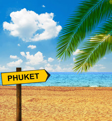 Tropical beach and direction board saying PHUKET