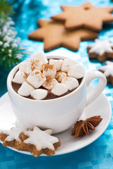 hot chocolate with marshmallows on a blue background, vertical