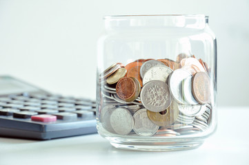 Coins in the glass jar (mixed Asian currencies)