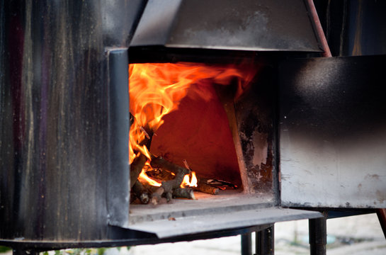 Black iron oven on fire