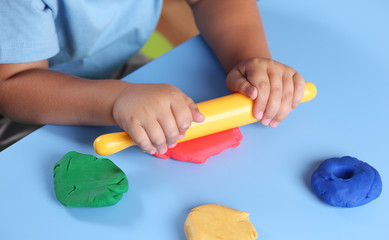 Child playing with modeling clay