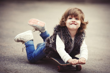 cute little hipster girl with skateboard