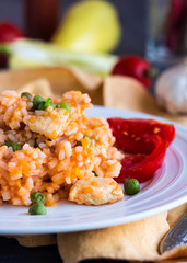 Risotto with chicken, peas and tomatoes, Italian food
