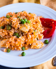 Risotto with chicken, peas and tomatoes, Italian food