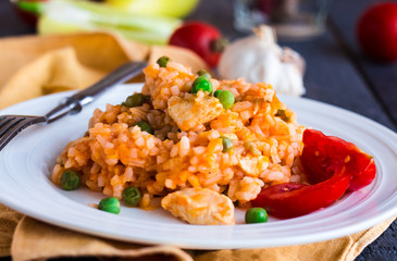 Risotto with chicken, peas and tomatoes, Italian food
