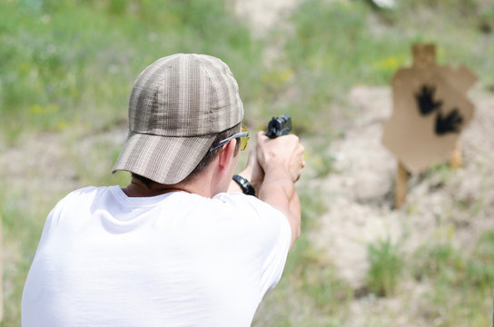 Man shoots a gun at the shooting range