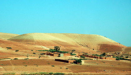 Fototapeta premium Morocco, house at the foot of a hill in the desert