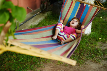 cute girl resting lying on hammock