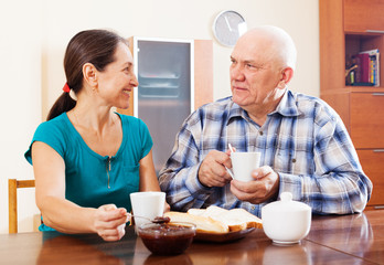 Fototapeta na wymiar mature couple having tea with jam