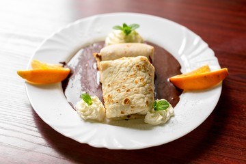 Delicious pancakes with chocolate sauce