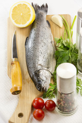 raw fish on a cutting board and knife