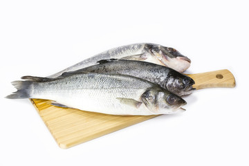 raw fish on a cutting board and knife