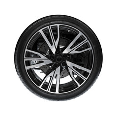 Photo of new automotive wheel on black disc isolated on white ba