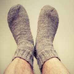 Closeup photo of male feet with gray woolen socks