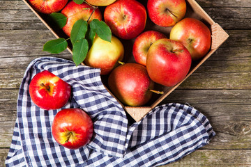 Fresh red apples in a wooden crate