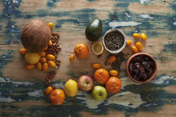 Fresh fruit, nuts and seeds on a rustic table