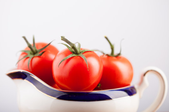 Tomatoes in a white china jug