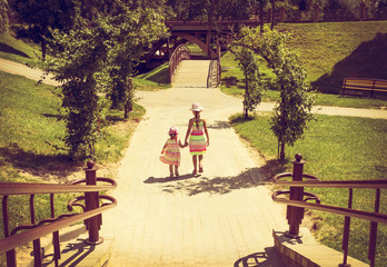 Fototapeta premium vintage portrait of Little girls running with sunset