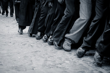 Fototapeta na wymiar black and white shot of male feet walking