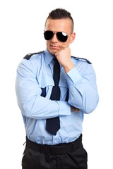 Portrait of thinking young policemen in sunglasses