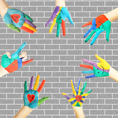 Painted hands on bricks wall background