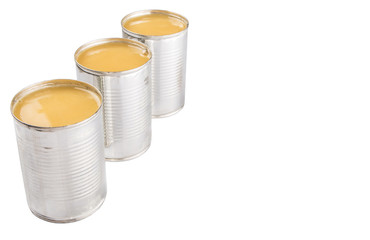Condensed milk in tin can over white background 