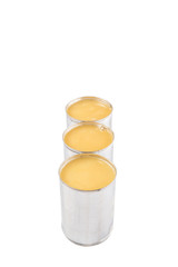 Condensed milk in tin can over white background 