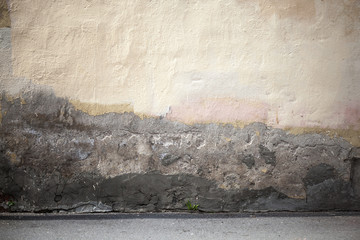 Grunge city background with old wall and asphalt