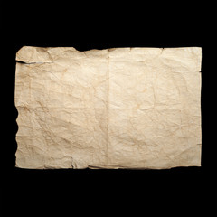 Sheet of old yellow crumpled paper isolated on black
