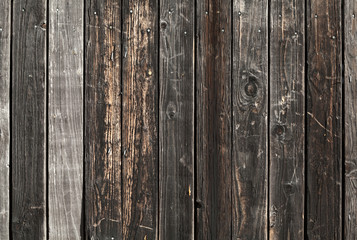 Naklejka premium Old dark brown wooden wall background photo texture