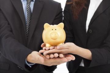hands of business people holding a piggy bank .financial concept