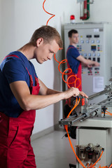 Workers next to machines in factory