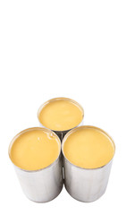 Condensed milk in tin can over white background 