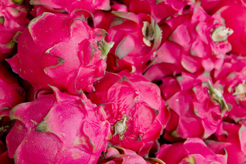 stack of dragon fruit in market background © ponsulak