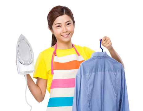 Asian housewife hold iron and shirt