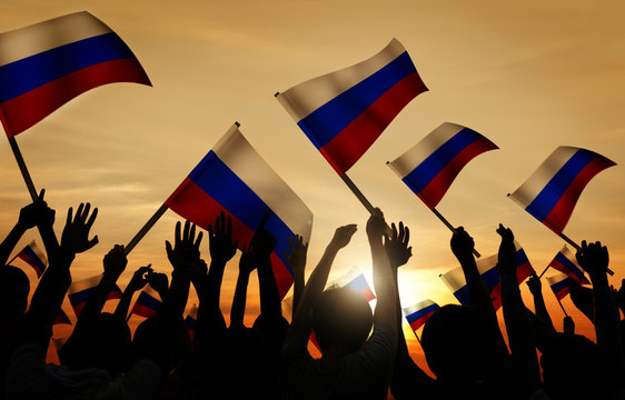 Silhouettes of People Holding Flag of Russia