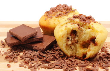 Fresh baked muffins, grated and portion of chocolate