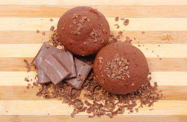 Fresh baked muffins, grated and portion of chocolate