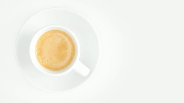 cup of coffee rotating overhead on white background