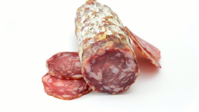 traditional salami sliced rotating on white background